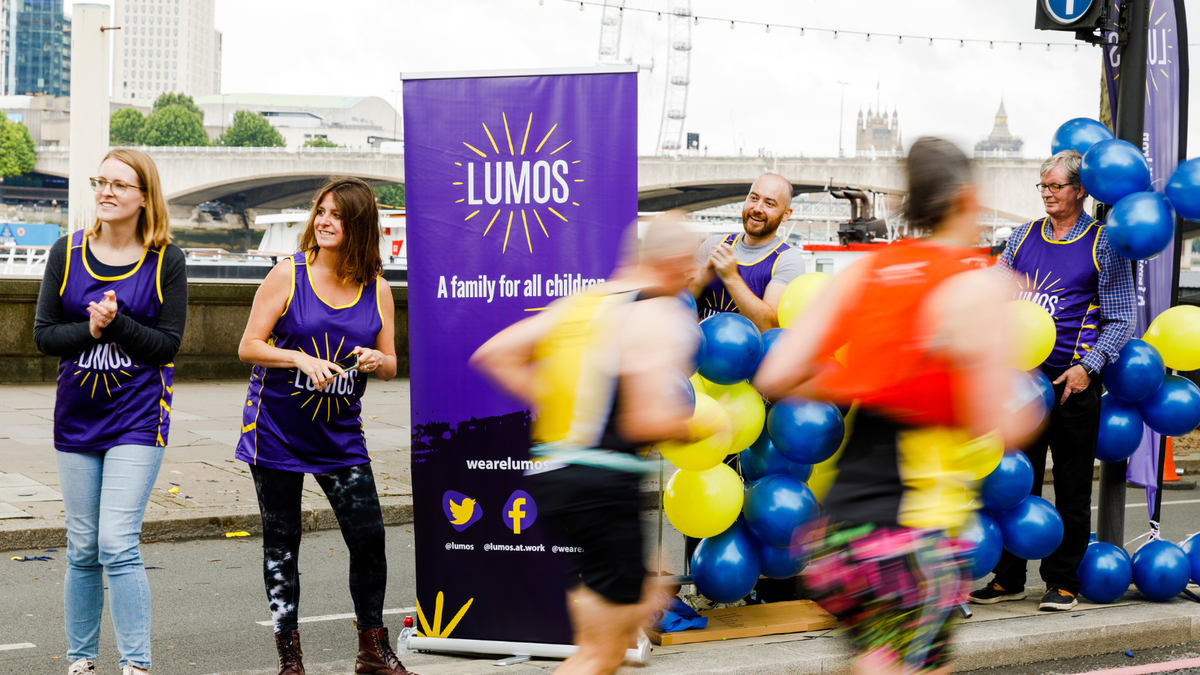 A runner with his hands up at the London Landmarks Half Marathon